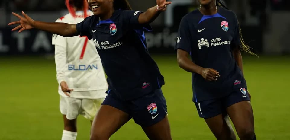Players celebrating a goal during NWSL match