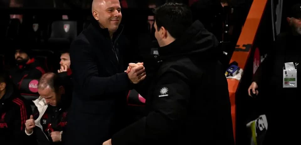 Coaches shaking hands on the sidelines during match