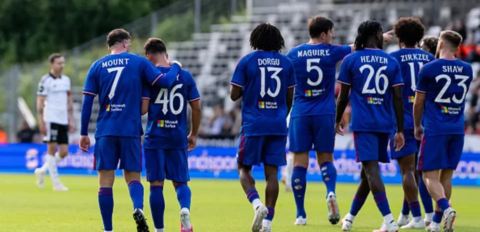 Players in blue jerseys celebrating on the pitch