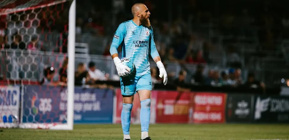 Goalkeeper holding ball during USL Championship match