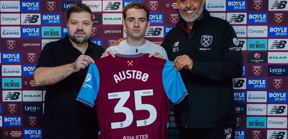 Player holding jersey with 'AUSTBØ 35' at signing event