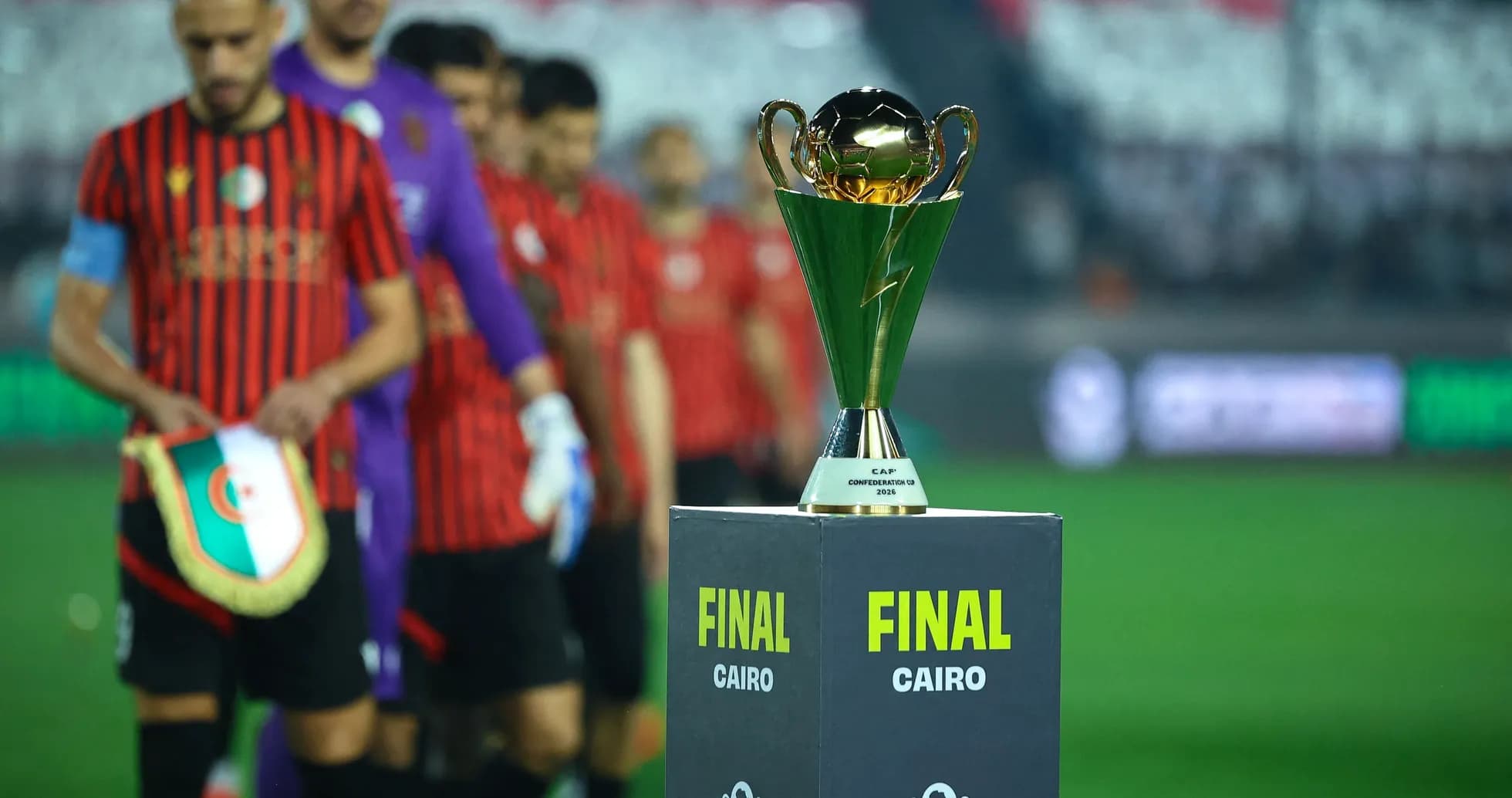 Teams entering field with trophy for final match