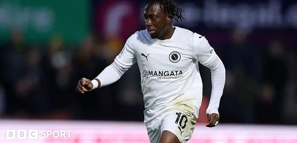 Player celebrating in white jersey after scoring