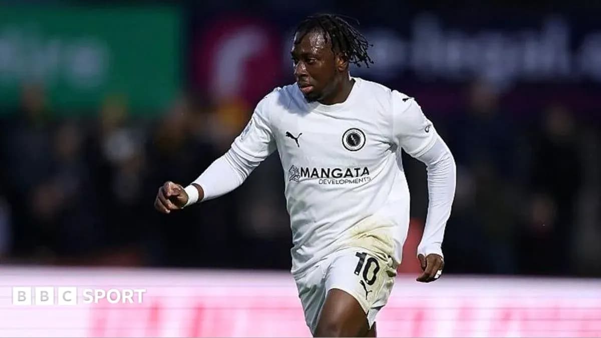 Player celebrating in white jersey after scoring