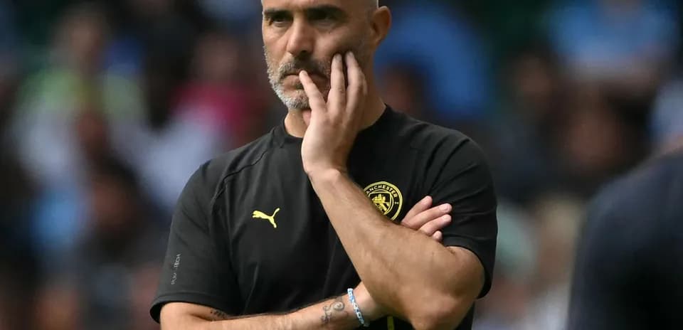 Coach observing game with hand on chin