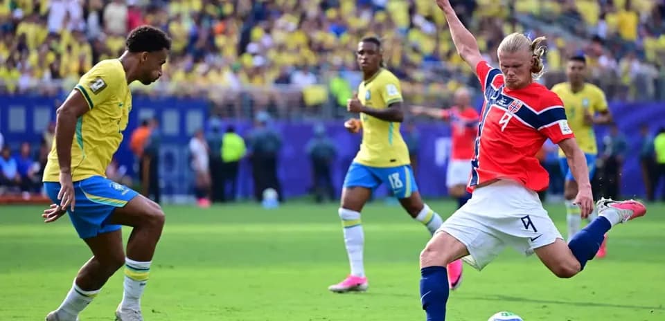Brazil player challenging Norway player during match