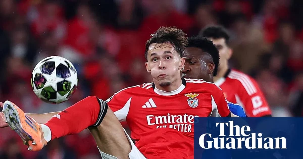 Benfica player kicking ball during match action