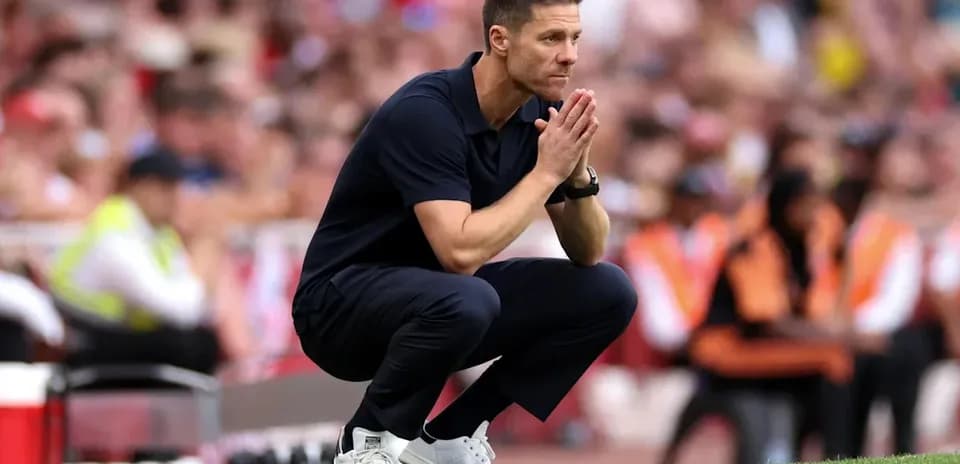 Coach crouching on the sideline during match