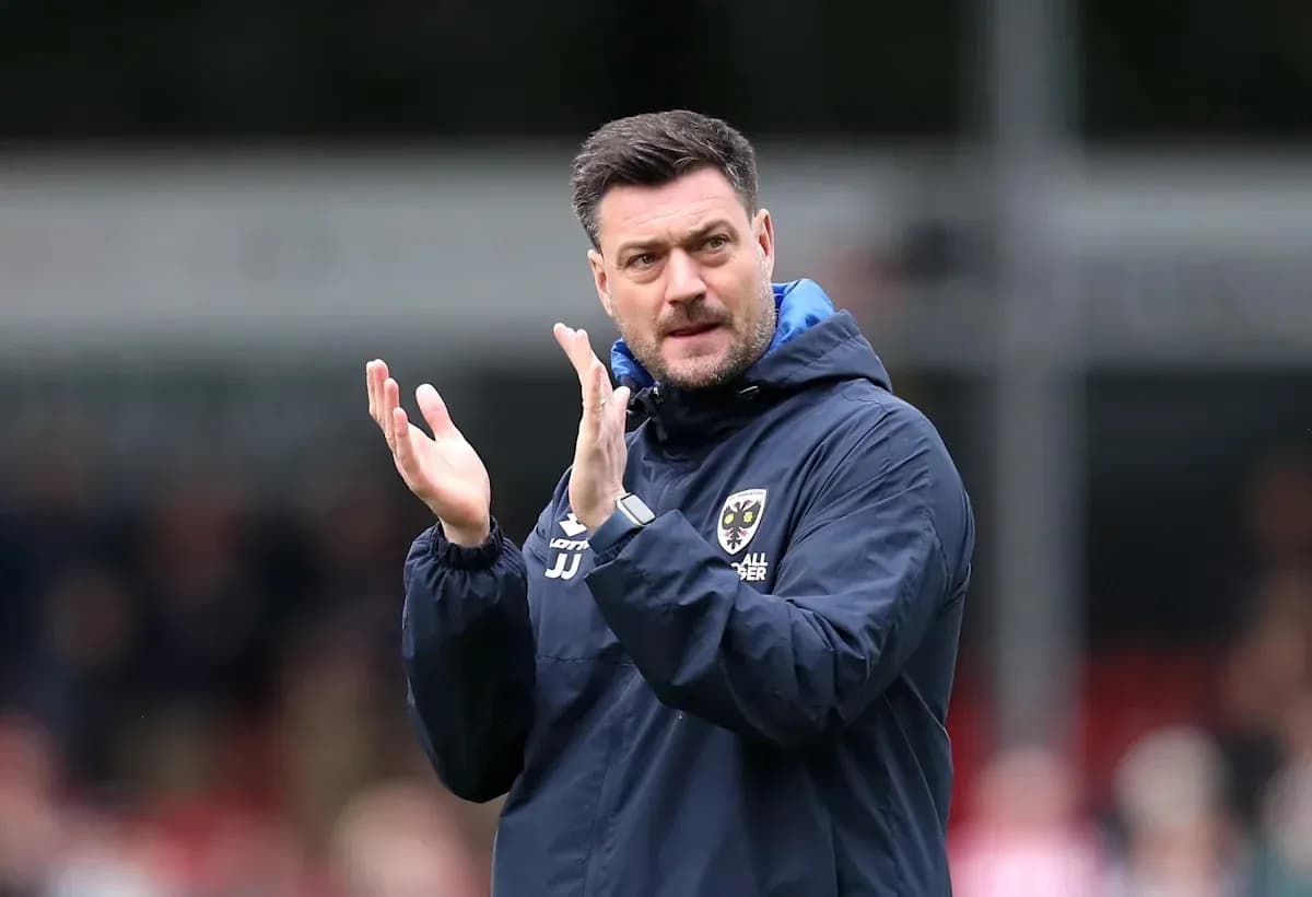 Coach applauding during a match on the sidelines