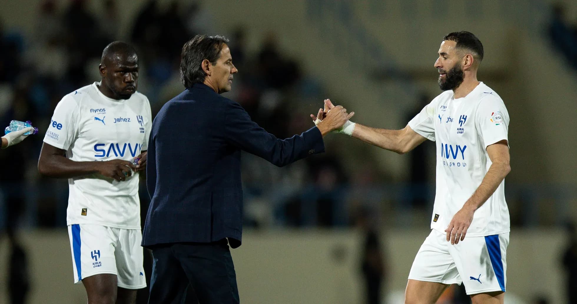 Coach shaking hands with player during match Coach shaking hands with player during match