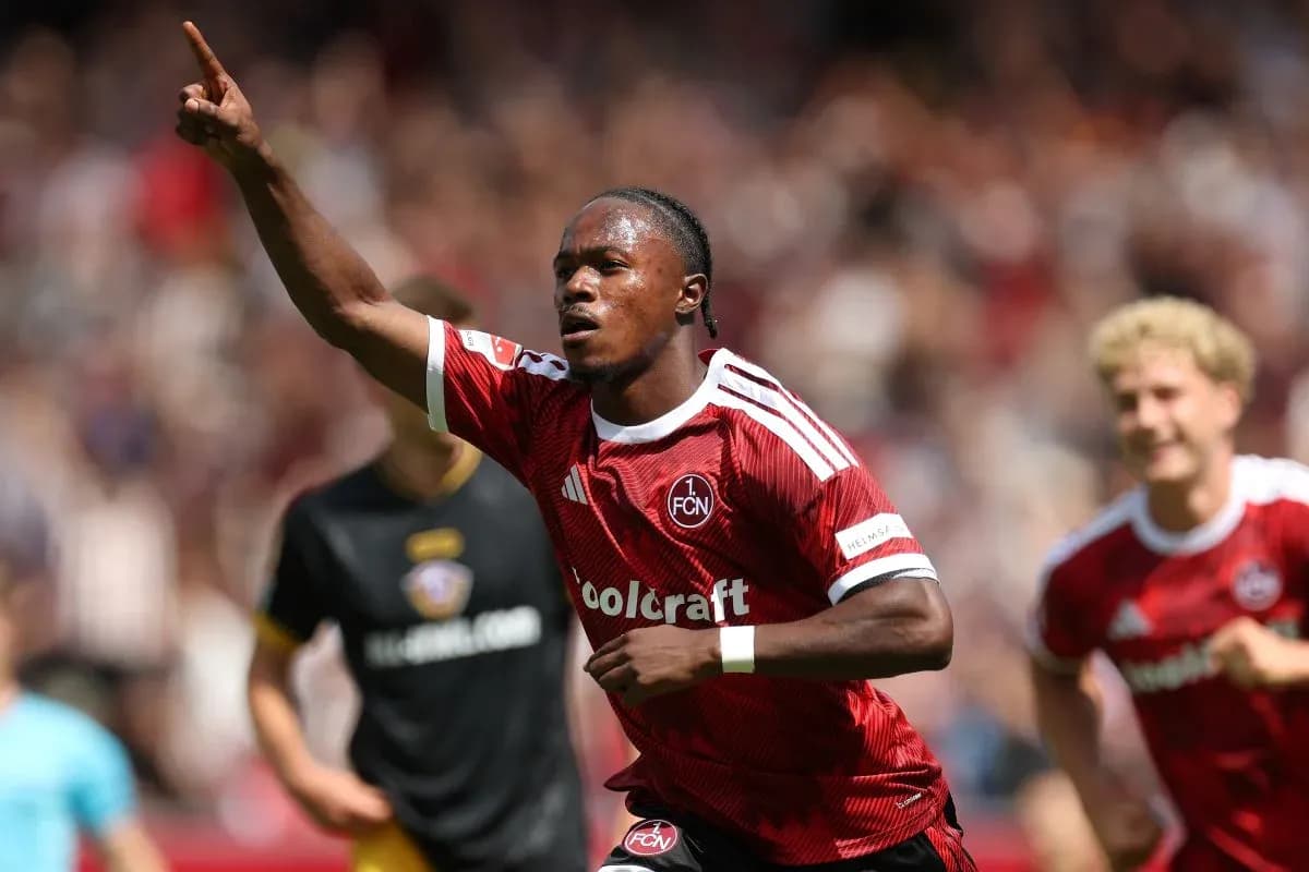 Player celebrating goal during match in red jersey Player celebrating goal during match in red jersey