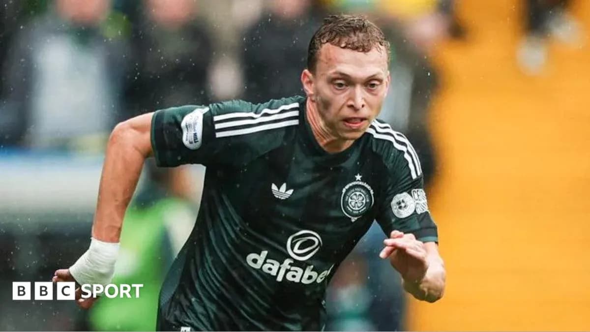 Player sprinting in dark green football kit during match Player sprinting in dark green football kit during match