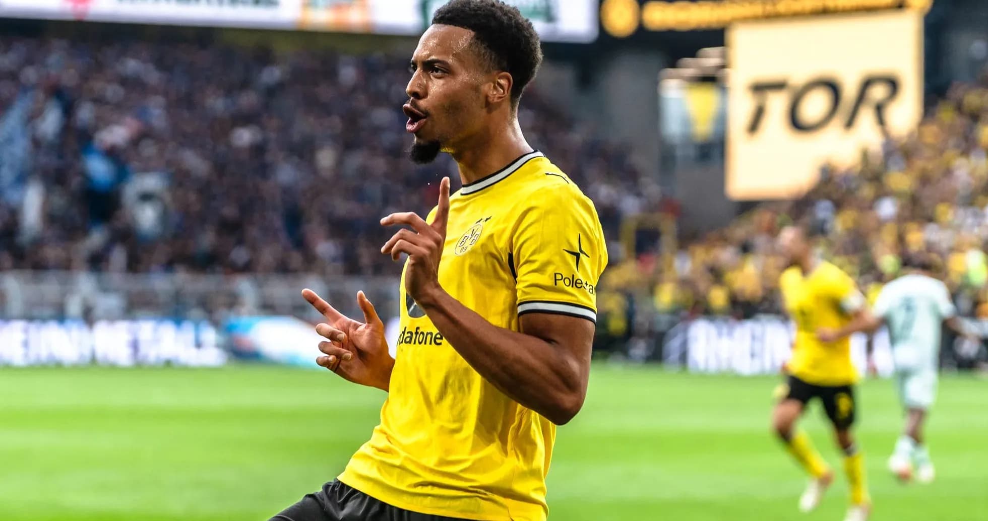 Player celebrating a goal in yellow team jersey Player celebrating a goal in yellow team jersey