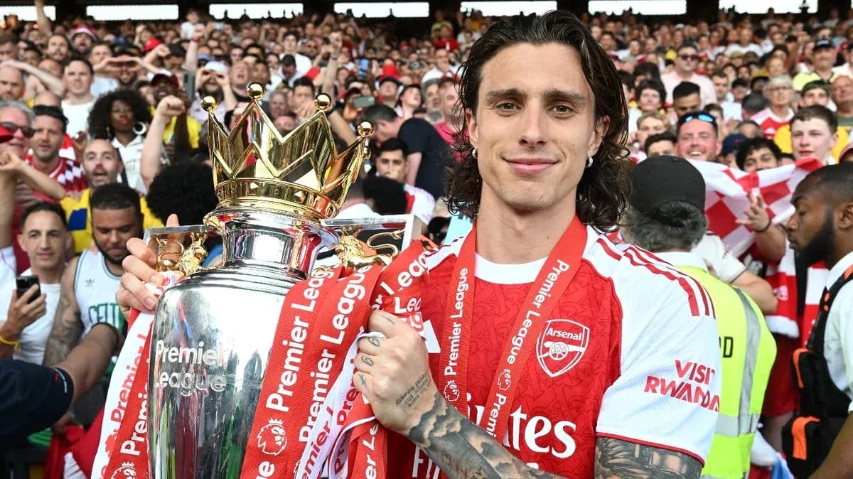 Player holding Premier League trophy with fans celebrating Player holding Premier League trophy with fans celebrating