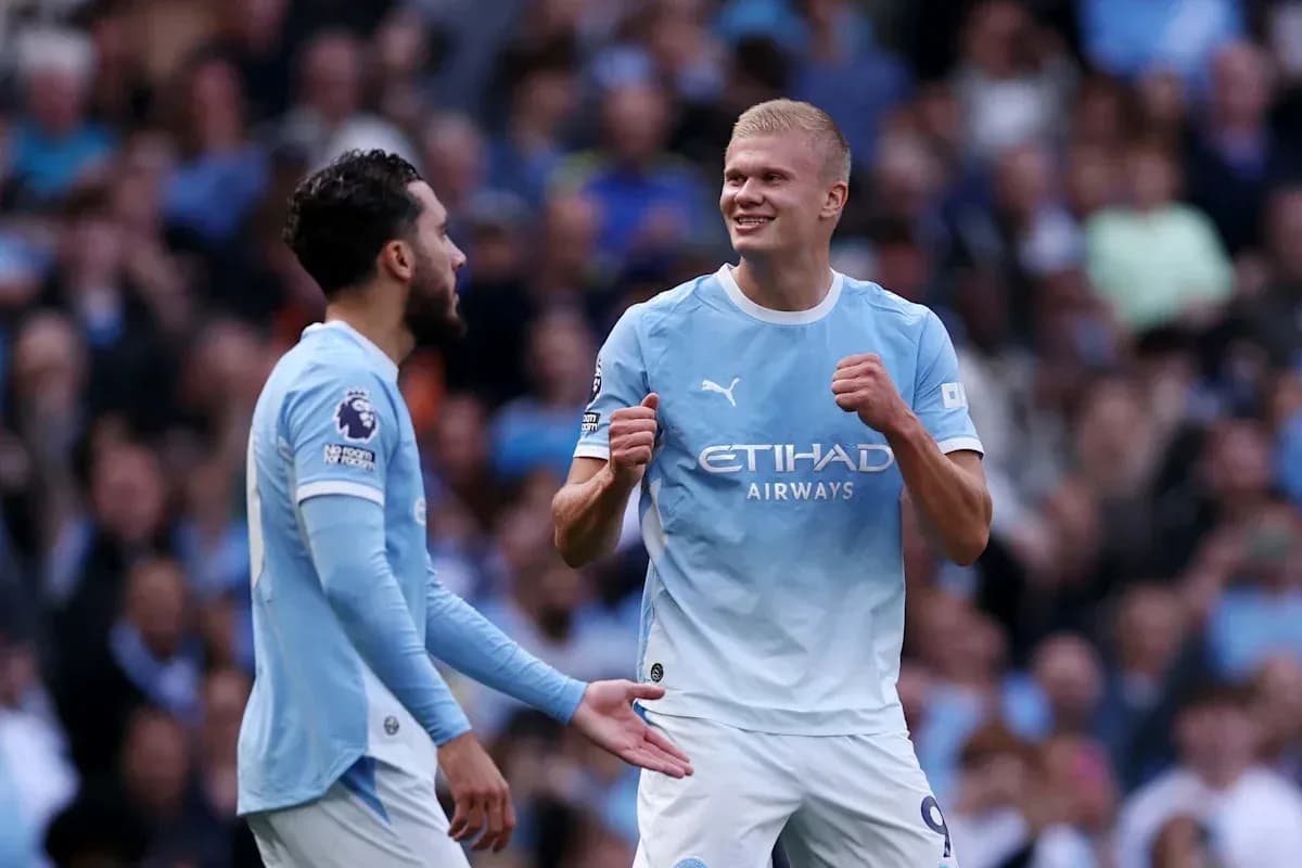 Manchester City players celebrating a goal together Manchester City players celebrating a goal together