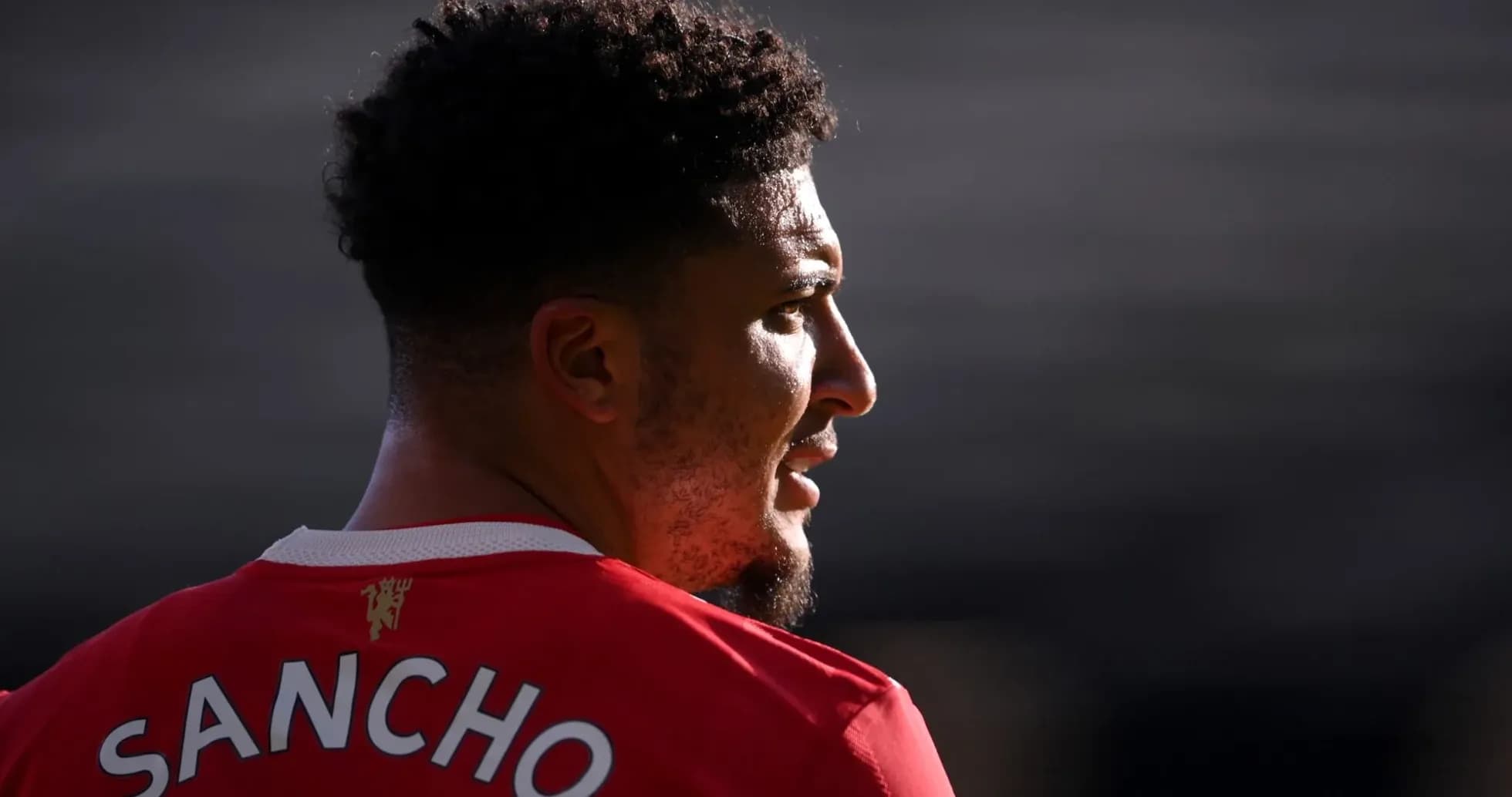 Player wearing red jersey with 'SANCHO' on back Player wearing red jersey with 'SANCHO' on back