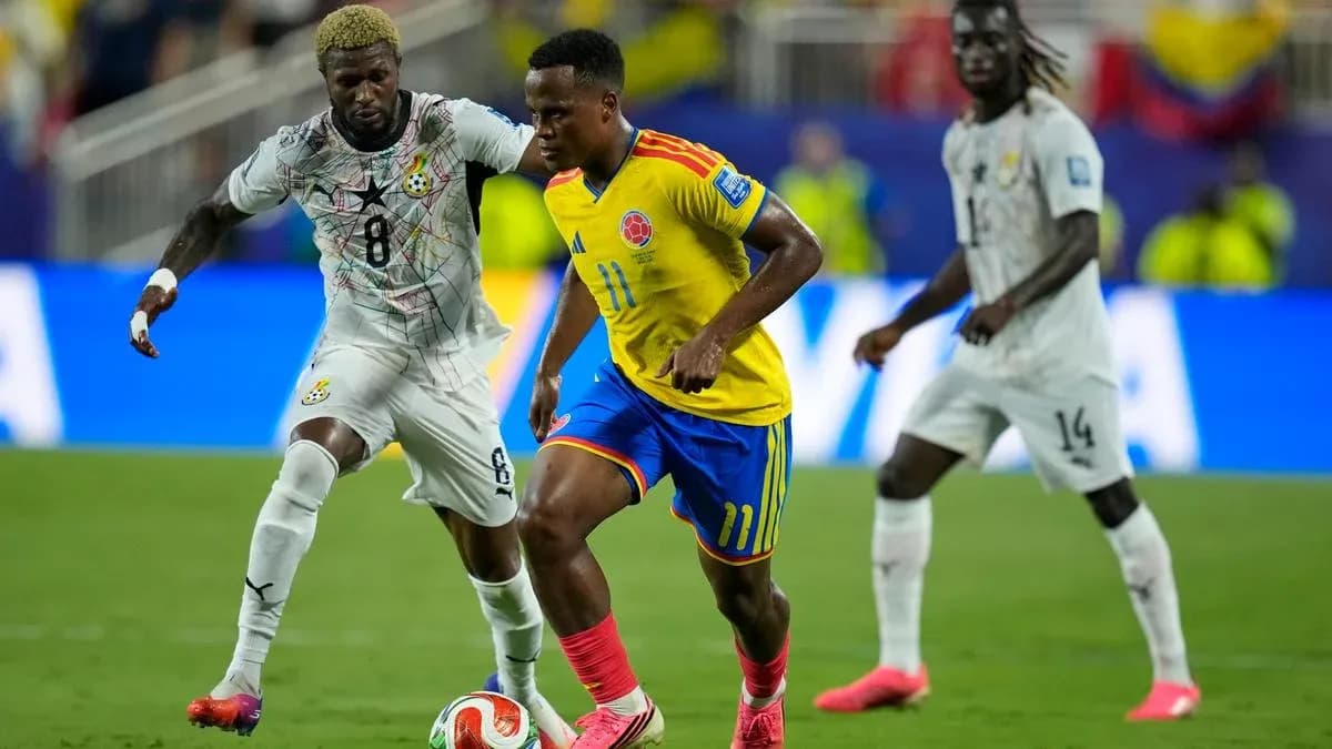 Colombian player dribbling past Ghanaian defender during match Colombian player dribbling past Ghanaian defender during match