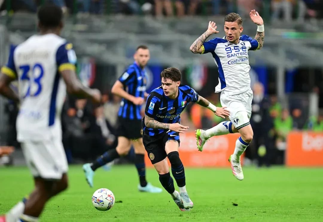 Inter player dribbling past Hellas Verona opponent Inter player dribbling past Hellas Verona opponent