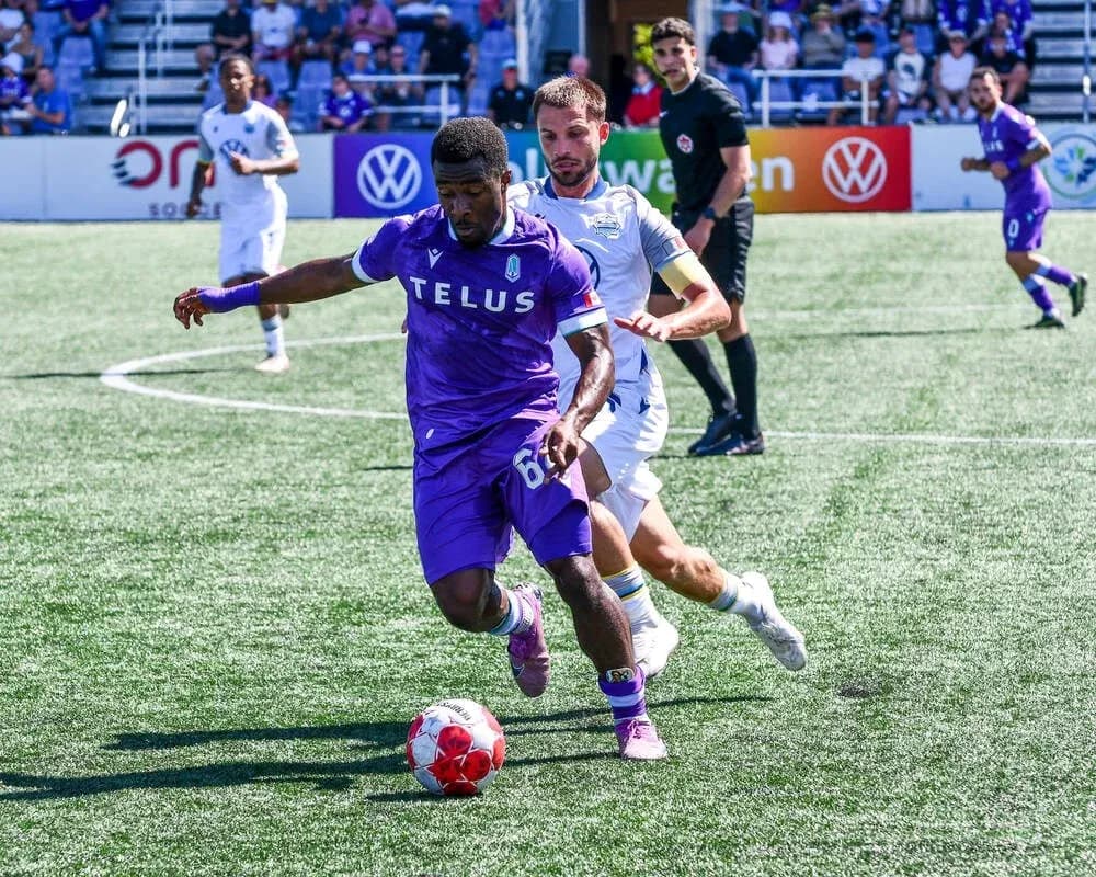 Pacific FC player dribbling the ball against HFX Wanderers Pacific FC player dribbling the ball against HFX Wanderers
