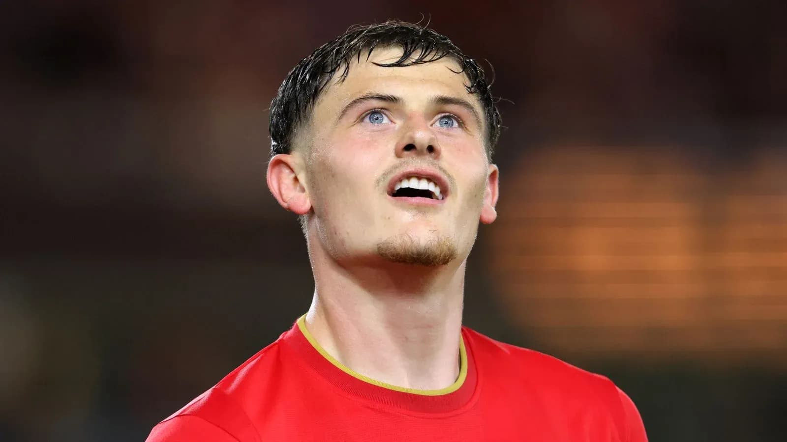 Player in red jersey looking up during match Player in red jersey looking up during match