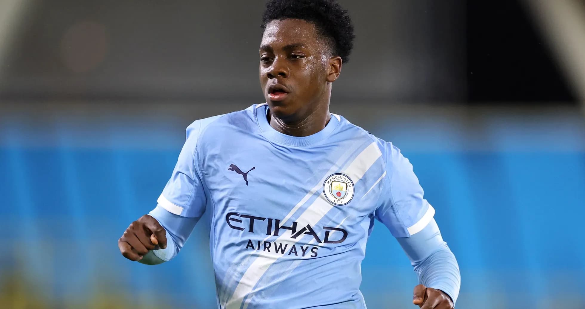 Player running in Manchester City training kit Player running in Manchester City training kit