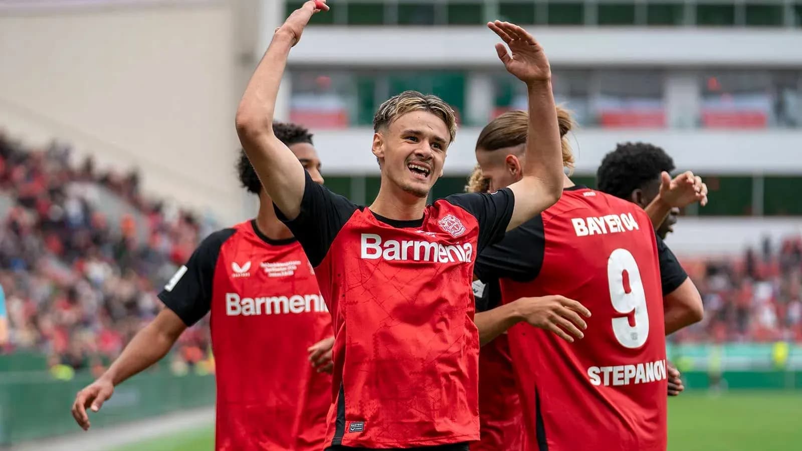 Bayer Leverkusen players celebrating a goal together Bayer Leverkusen players celebrating a goal together