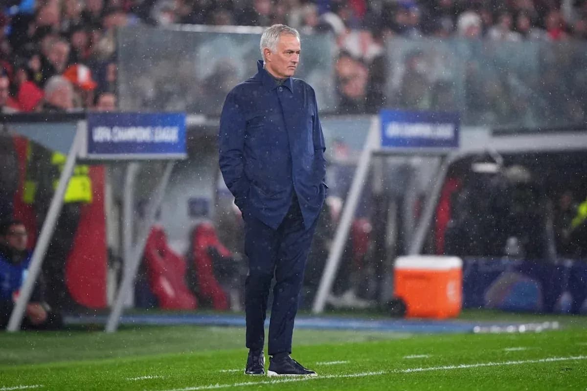 Manager standing on sideline during rainy match Manager standing on sideline during rainy match