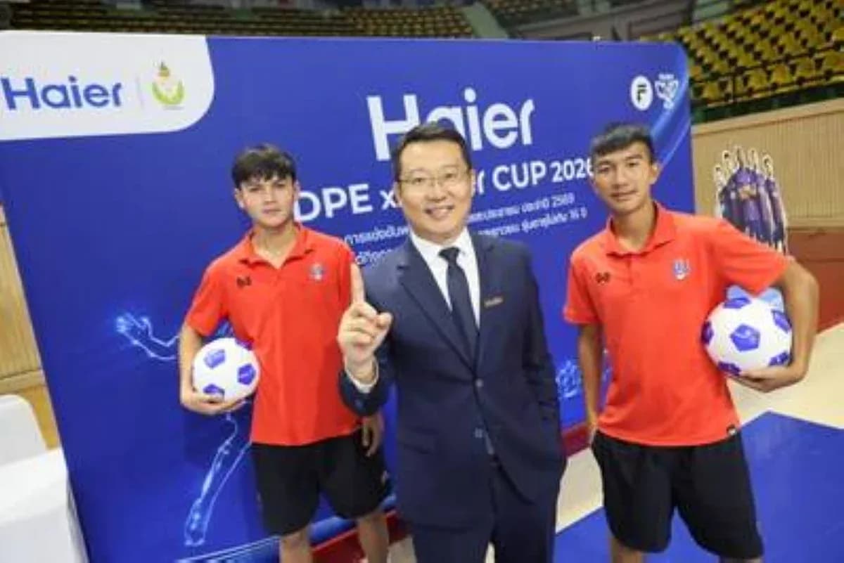 Two young players and a man posing with soccer balls Two young players and a man posing with soccer balls