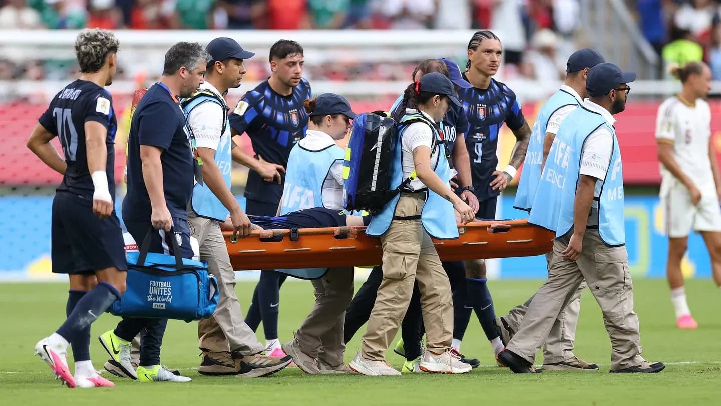 Medical team carrying player on stretcher during match Medical team carrying player on stretcher during match