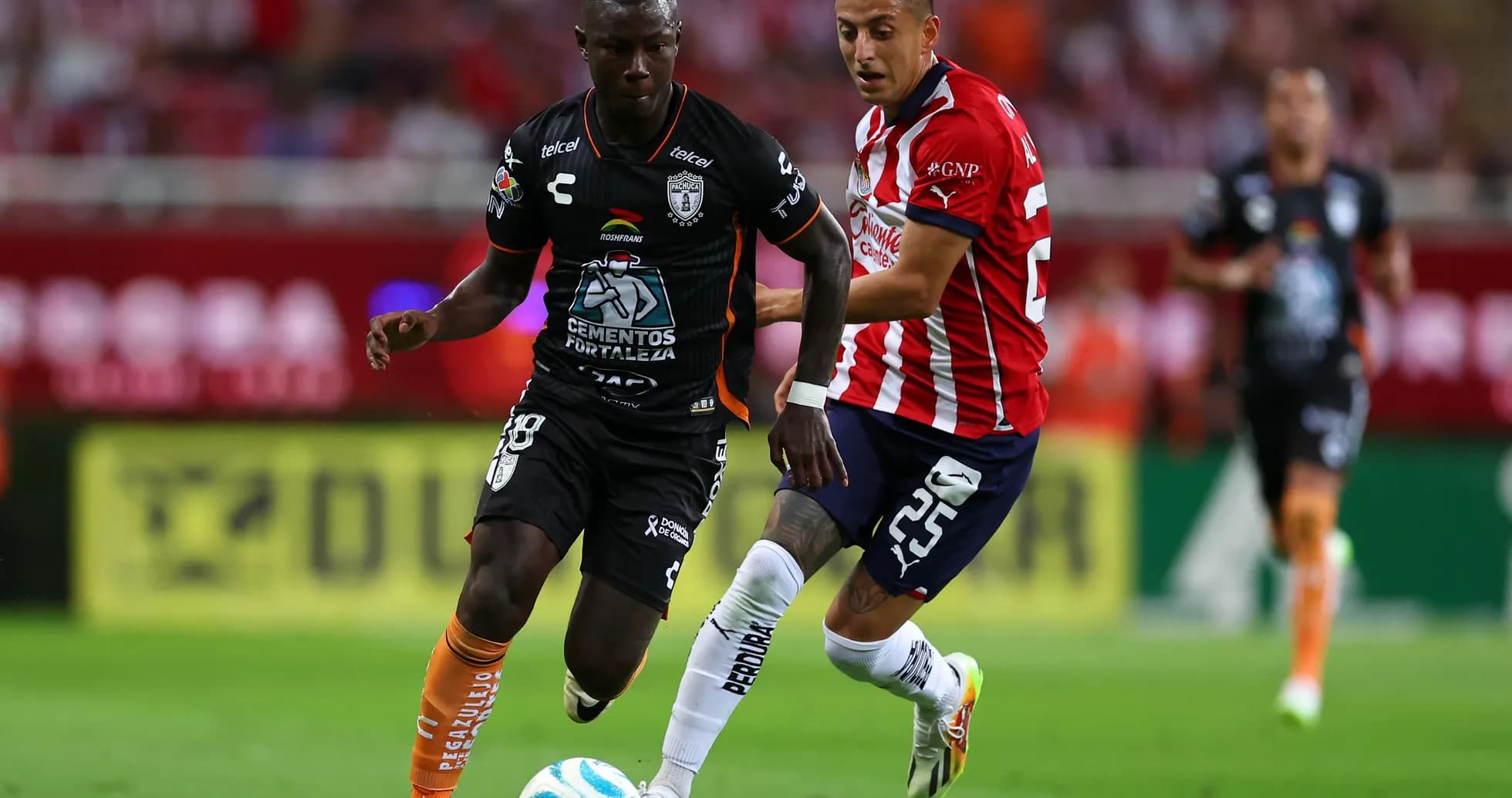 CF Pachuca player dribbling past Guadalajara Chivas player CF Pachuca player dribbling past Guadalajara Chivas player