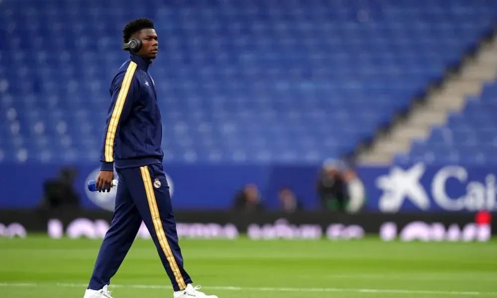 Player walking on pitch wearing headphones before match Player walking on pitch wearing headphones before match