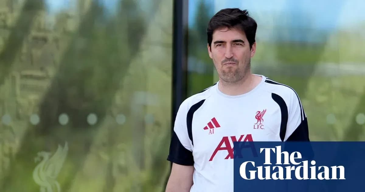 Man in Liverpool training kit walking outside Man in Liverpool training kit walking outside