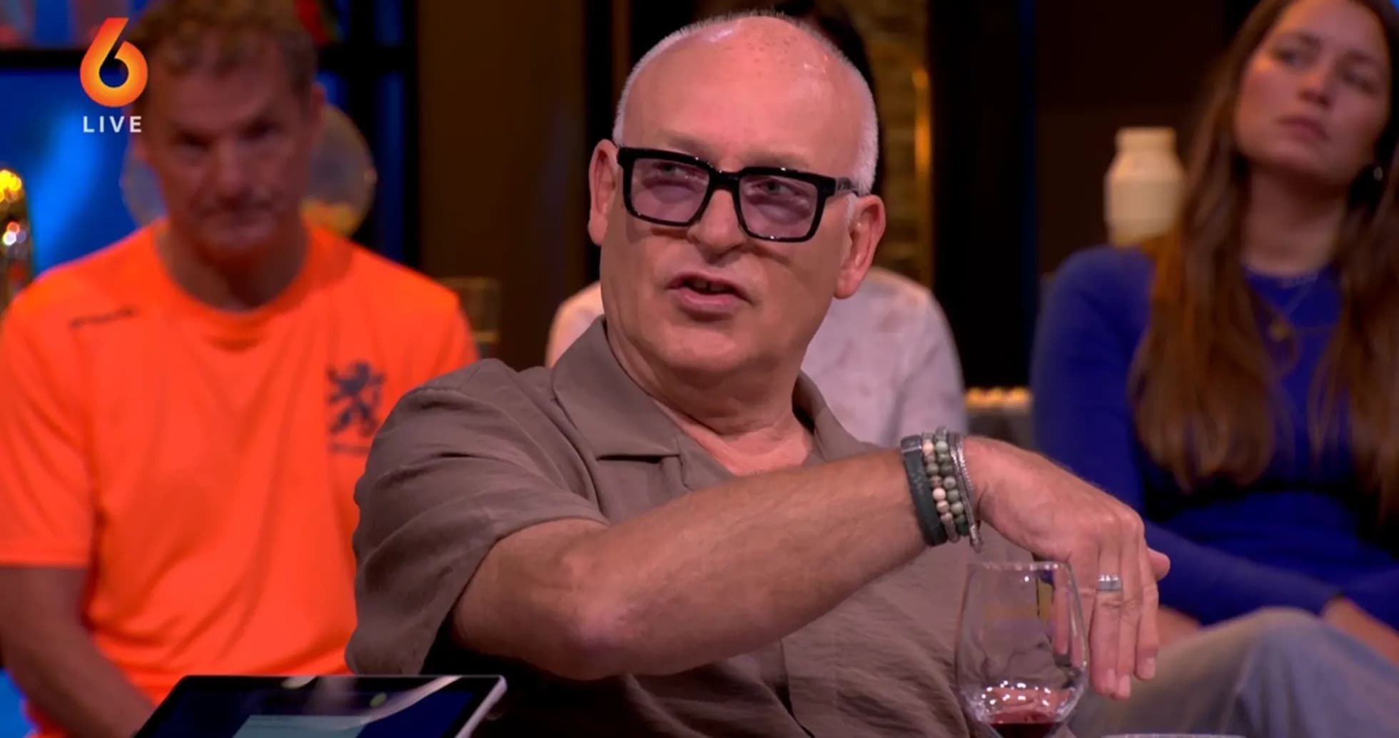 Man gesturing while speaking at a talk show Man gesturing while speaking at a talk show