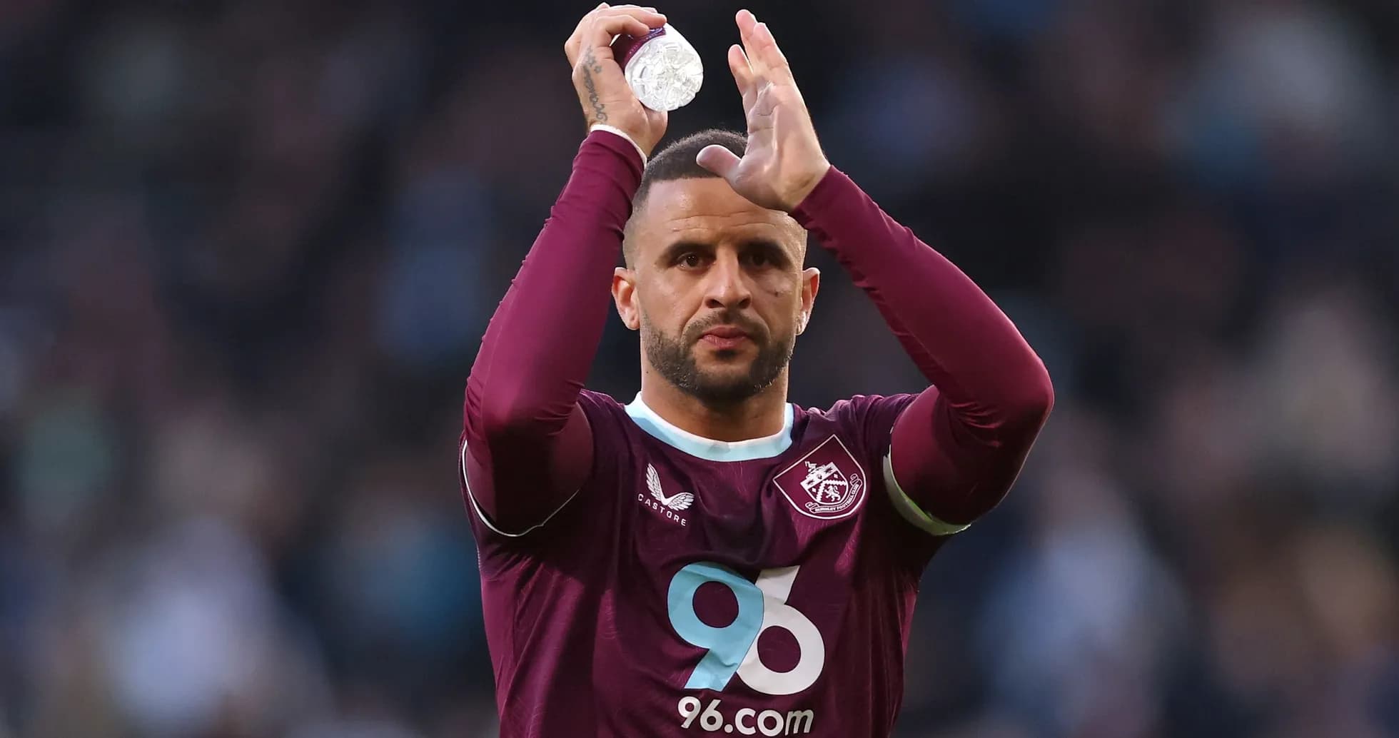 Player applauding while holding a water bottle Player applauding while holding a water bottle