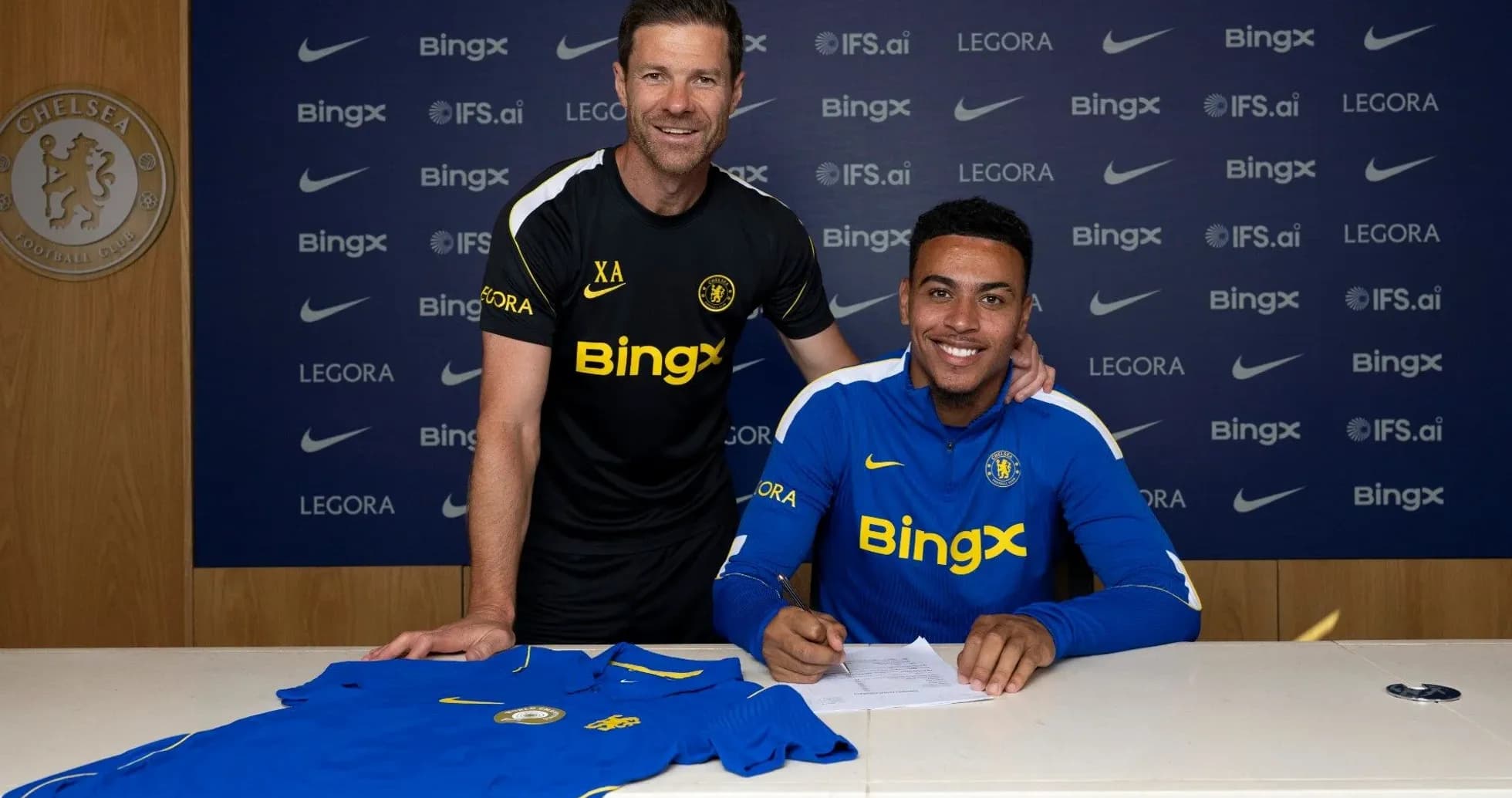 Player signing contract with coach at Chelsea FC Player signing contract with coach at Chelsea FC