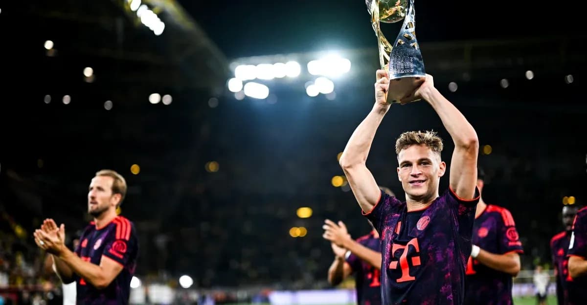 Player holding trophy with teammates celebrating behind Player holding trophy with teammates celebrating behind