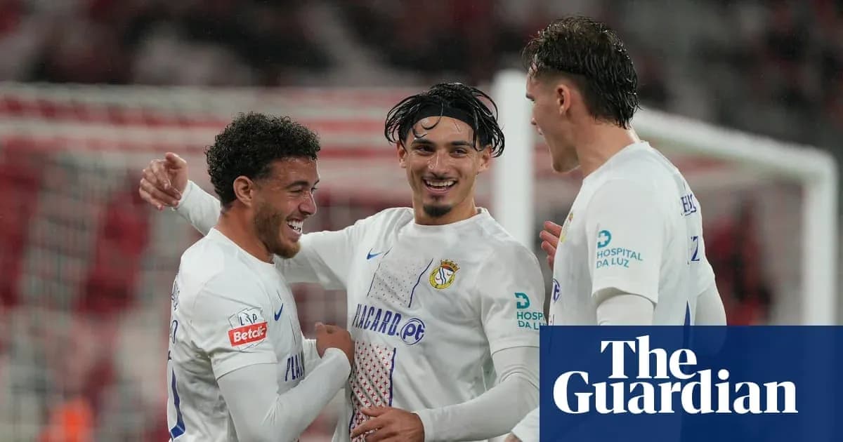 Three players celebrating a goal together on field Three players celebrating a goal together on field