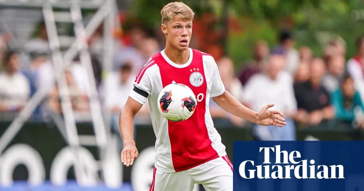 Player in Ajax kit controlling the soccer ball Player in Ajax kit controlling the soccer ball