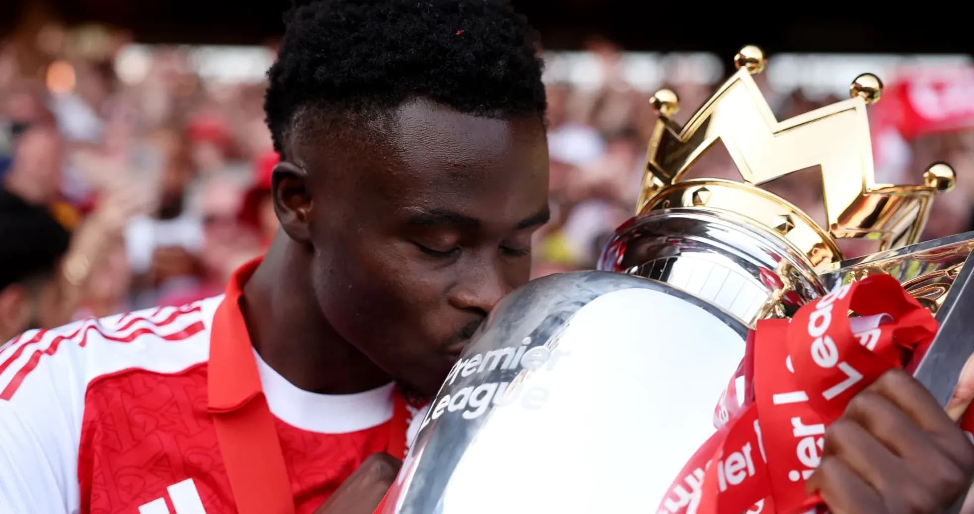 Player kissing the Premier League trophy during celebration Player kissing the Premier League trophy during celebration