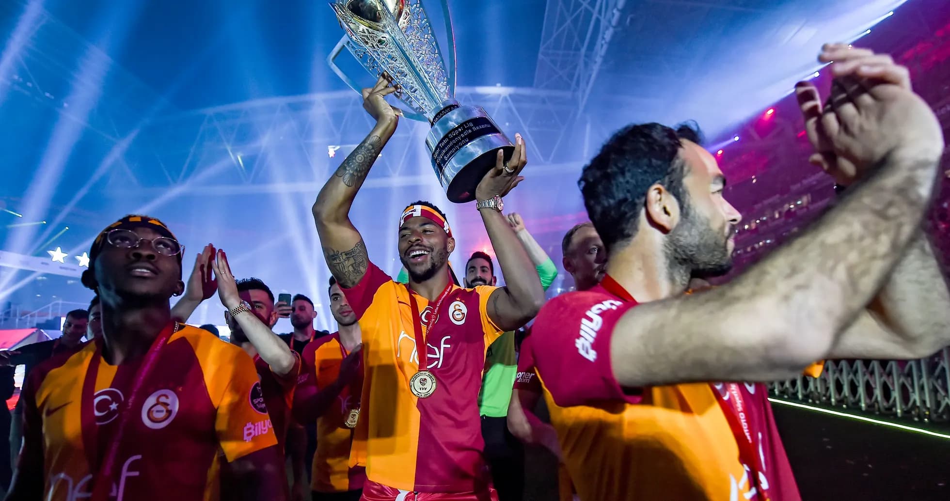 Player celebrating with trophy at victory parade Player celebrating with trophy at victory parade