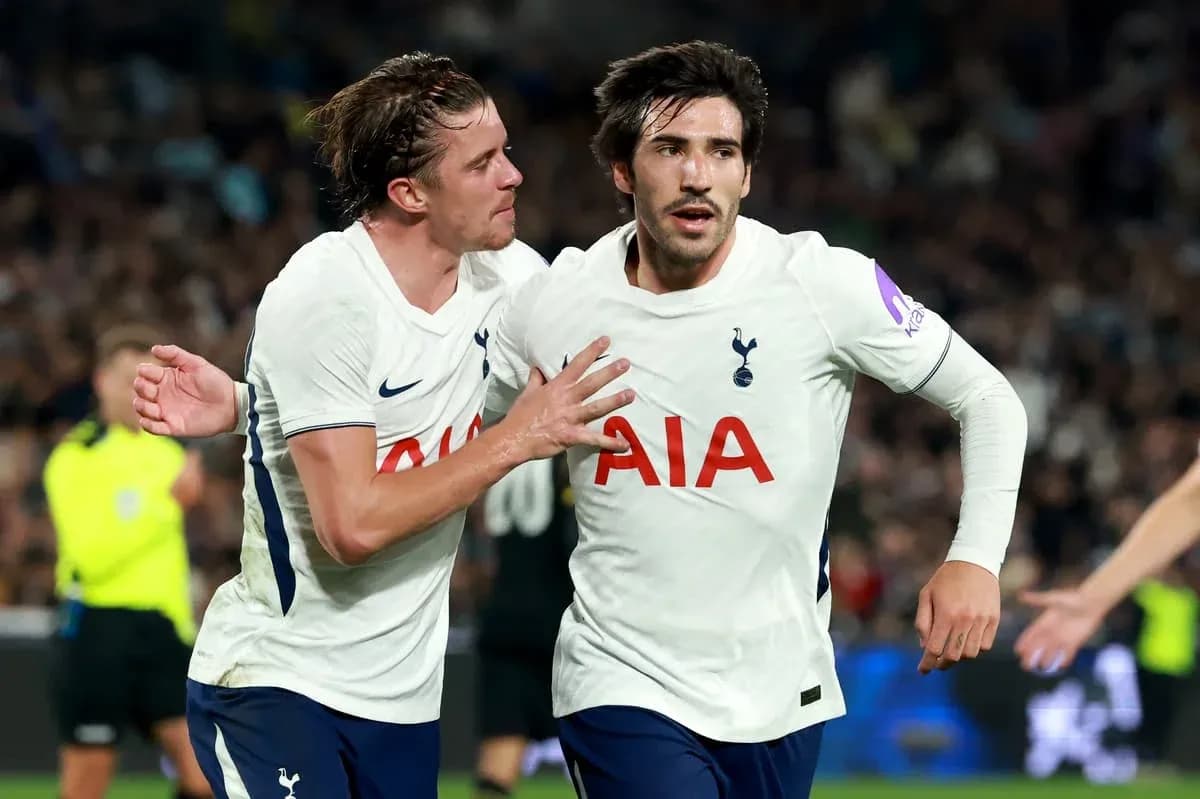 Tottenham players celebrating a goal on the pitch Tottenham players celebrating a goal on the pitch