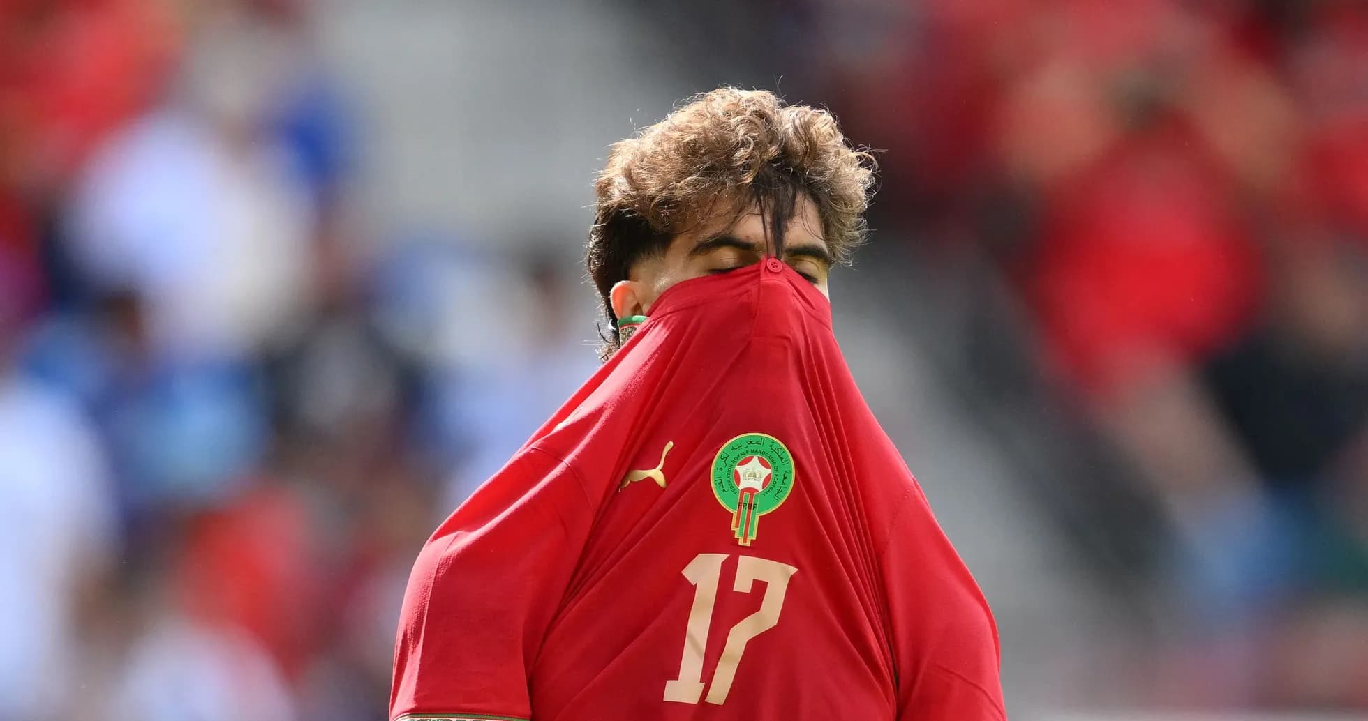 Player hiding face with jersey during match Player hiding face with jersey during match