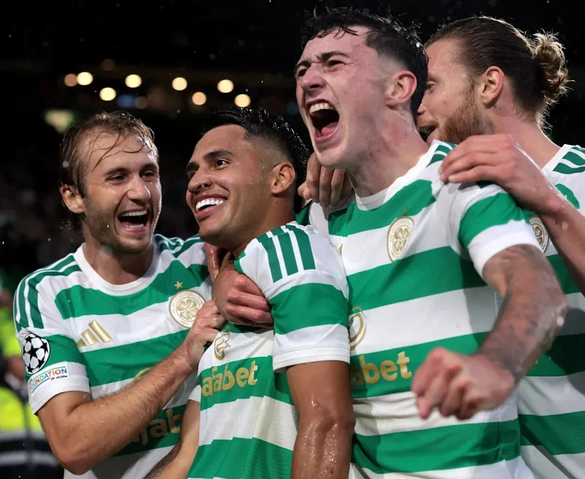 Celtic players celebrating a goal in match Celtic players celebrating a goal in match