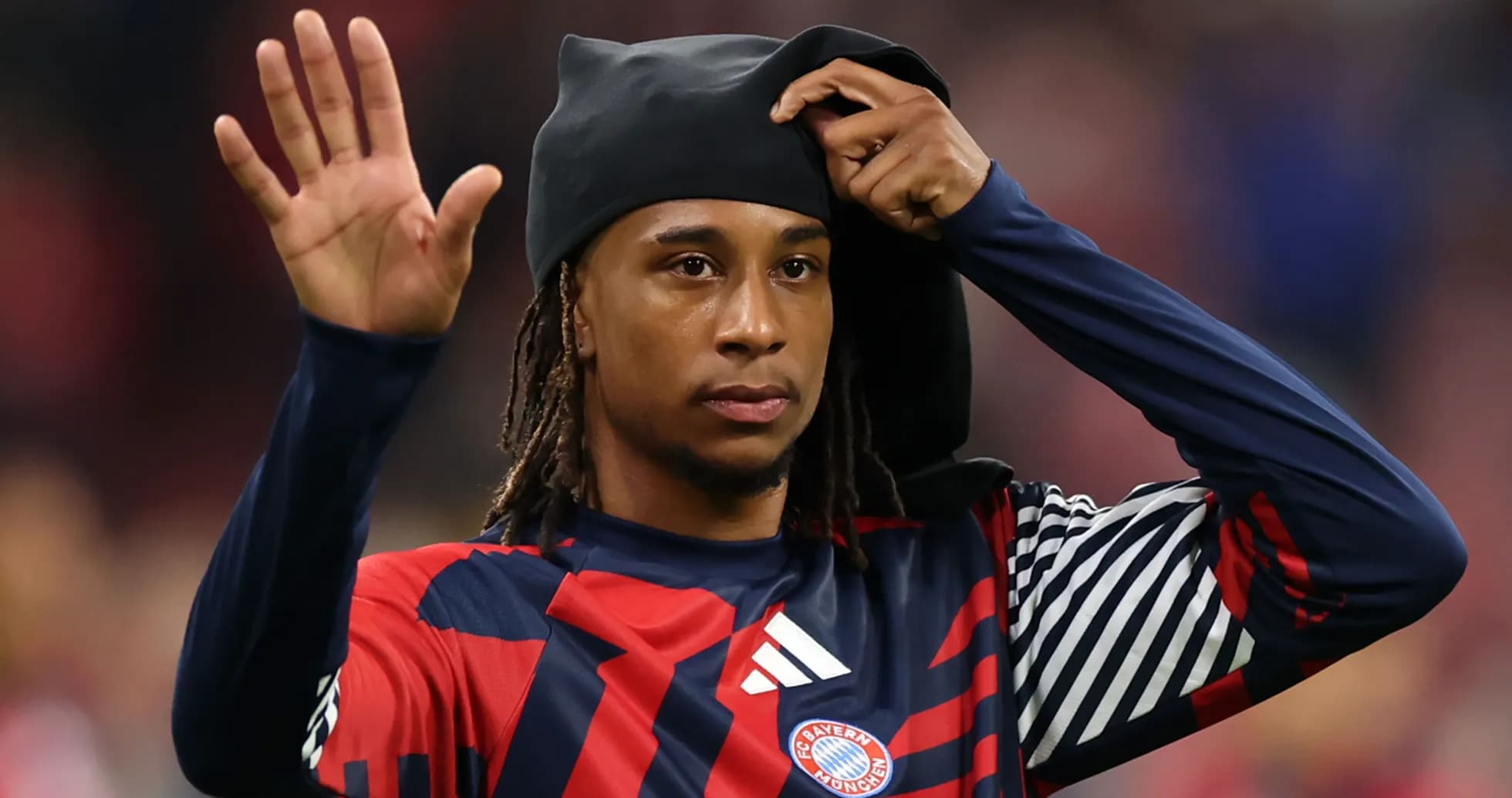 Bayern Munich player waving while adjusting headwear Bayern Munich player waving while adjusting headwear