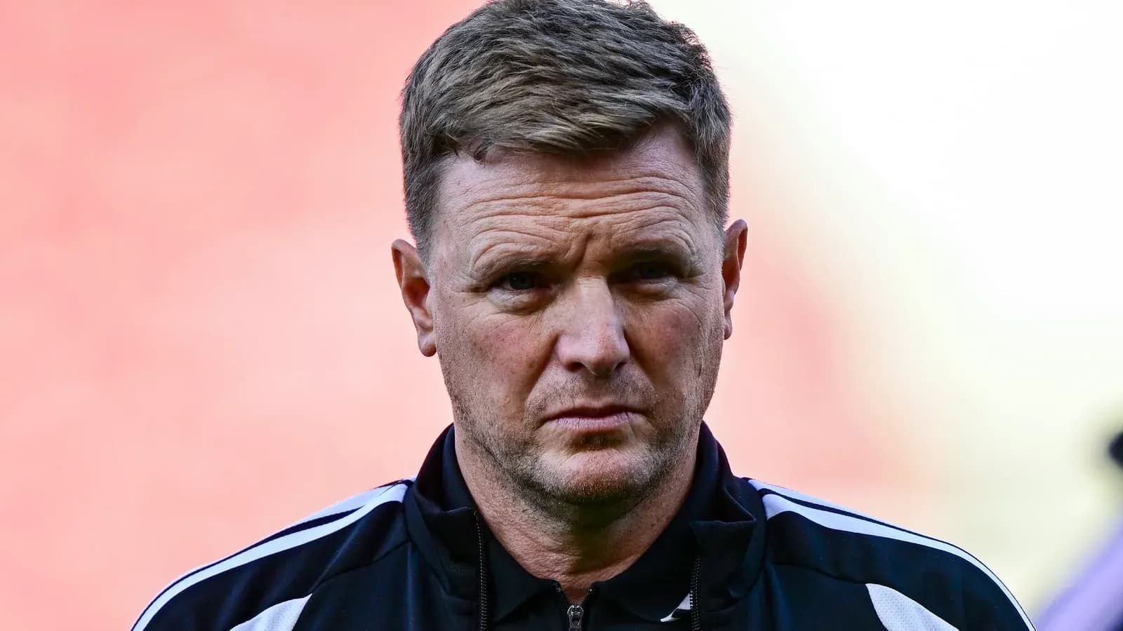 Manager in black training attire on field Manager in black training attire on field