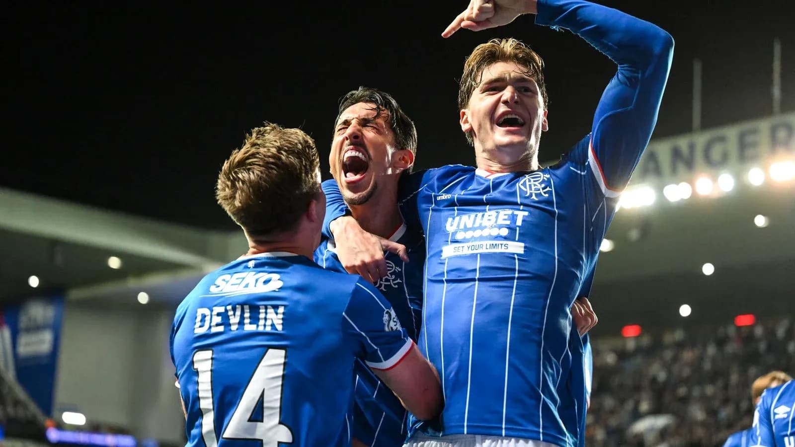 Rangers players celebrating a goal in match Rangers players celebrating a goal in match