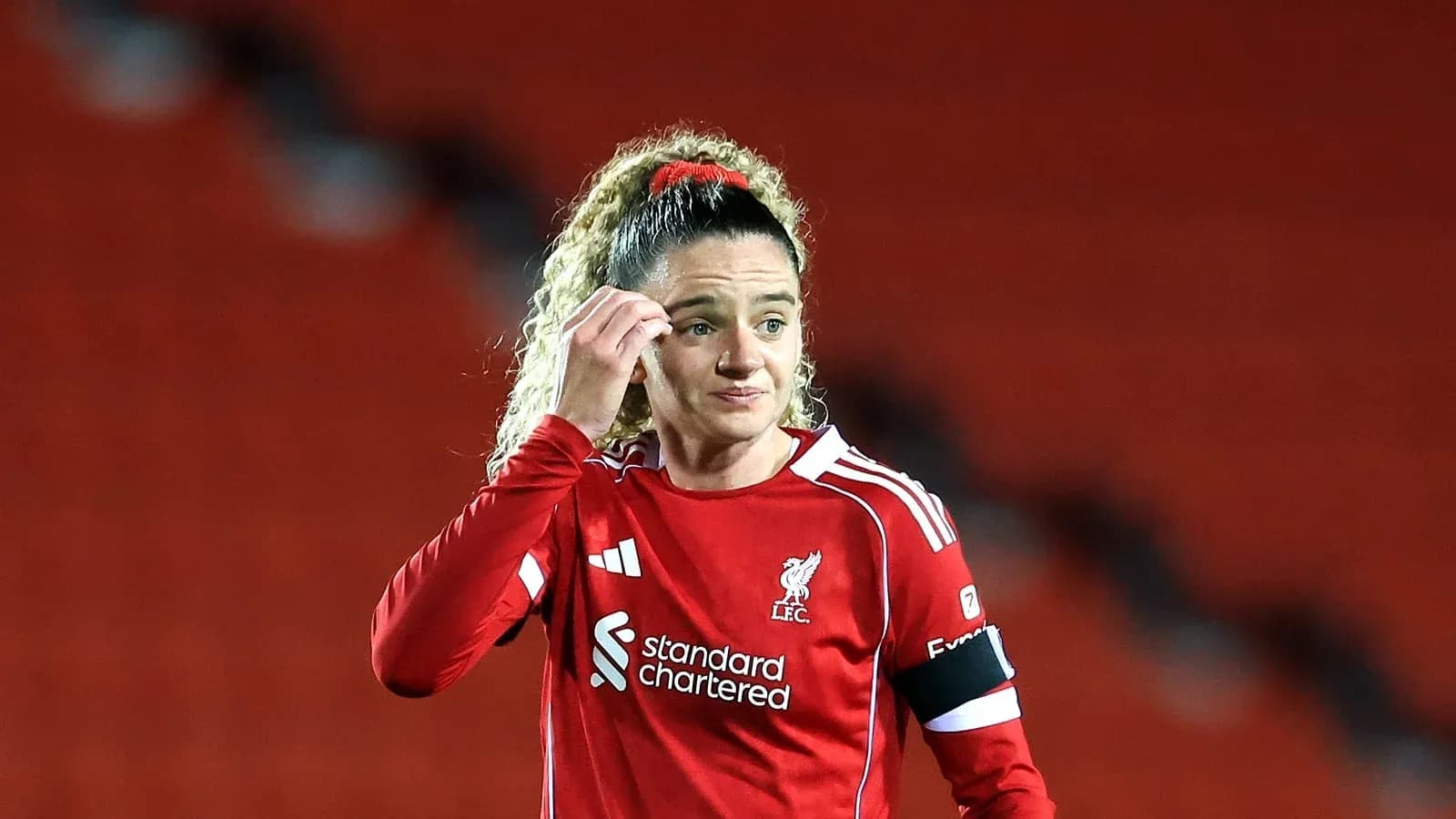 Female player in red Liverpool kit during match Female player in red Liverpool kit during match