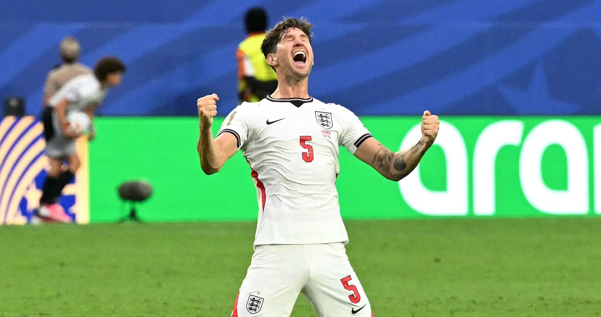 Player celebrating with fists raised on the field Player celebrating with fists raised on the field