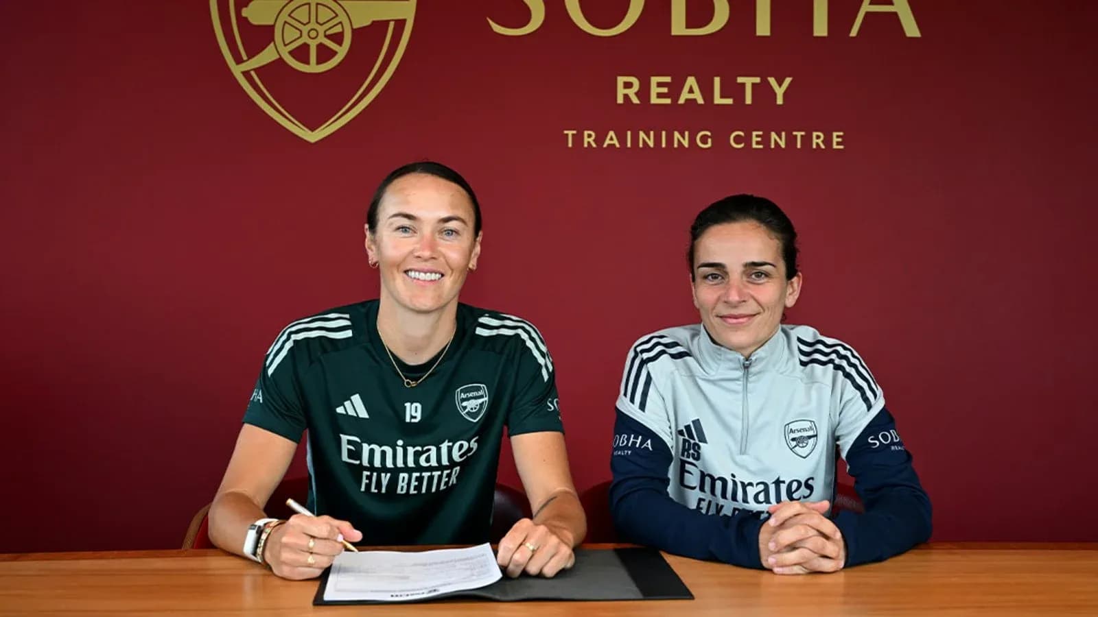 Two players signing contracts at training center Two players signing contracts at training center