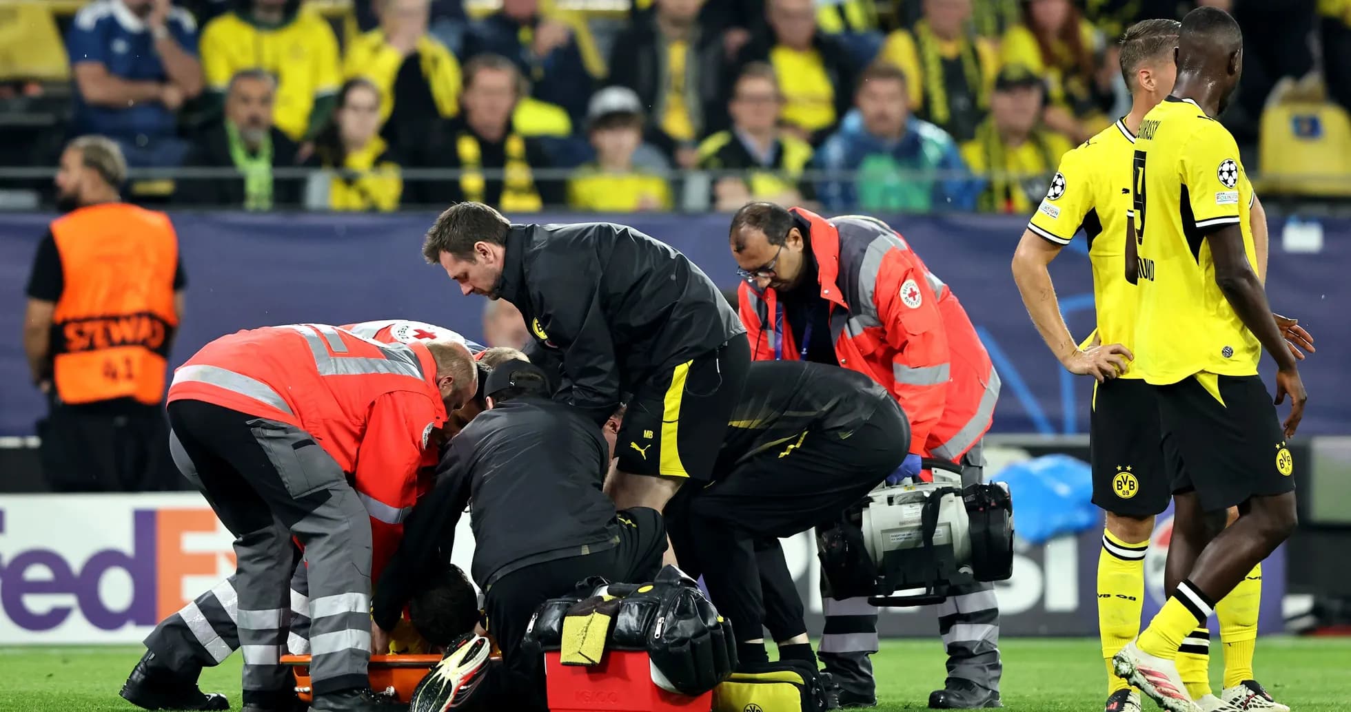 Medical team assisting injured player on field Medical team assisting injured player on field
